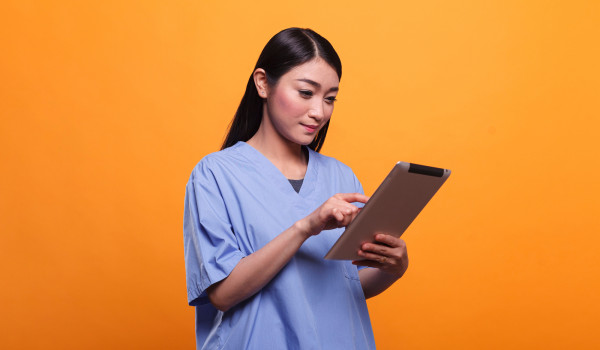 nurse orange background with tablet