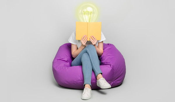 lightbulb person reading a book