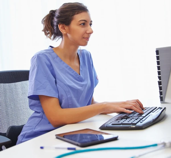 Image of nurse at computer desk