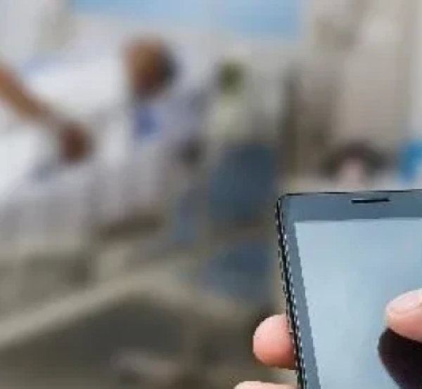 Image of man with phone in hospital