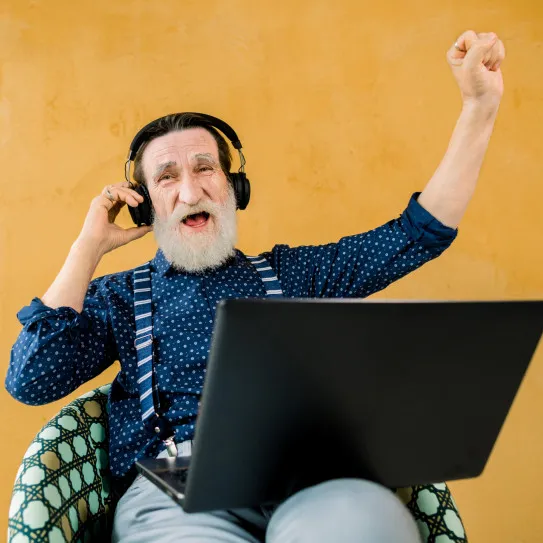 Image of man cheering with headphones on