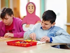 A picture of a System C social care character interacting with children.