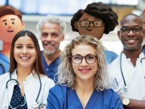 A picture of healthcare professionals smiling at the camera in a hospital setting.