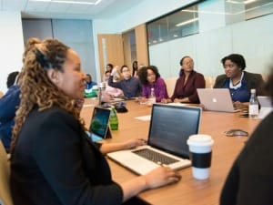 A picture of social workers in a meeting room having a discussion.