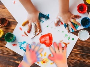 A picture of child's hands doing hand painting .
