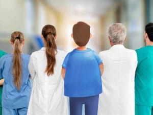 A picture of various healthcare workers facing away, stood with a System C character.