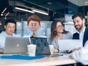 A picture of a innovative team sitting around a table with System C electronic devices.