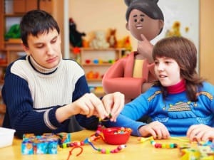 Two children playing with beads, being overlooked by a System C character.