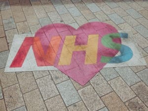 A picture of the NHS logo with a love heart in the middle.