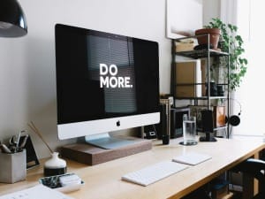 A picture of a computer screen on a modern desk.