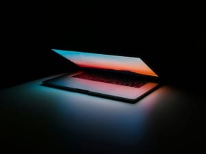 A picture of a laptop with a dark background.
