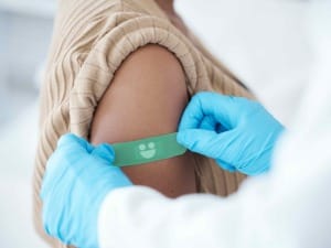 A clinician putting a System C plaster on a child's arm.