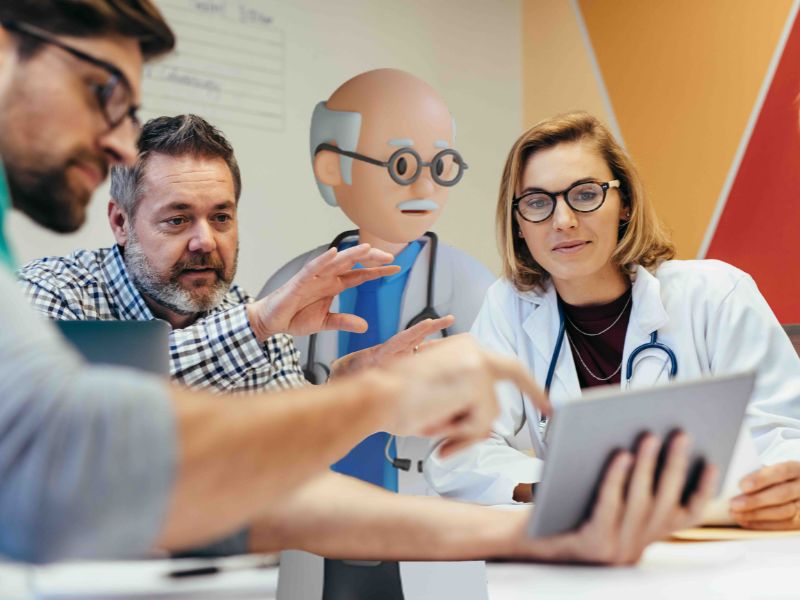 A picture of healthcare professionals using CareFlow EPR (Electronic Patient Record on an electronic device.
