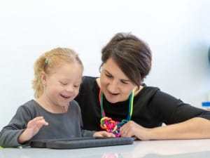 a picture of a social worker on an iPad with a child.