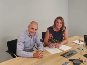 The Circle Health Group team signing the contract and smiling.