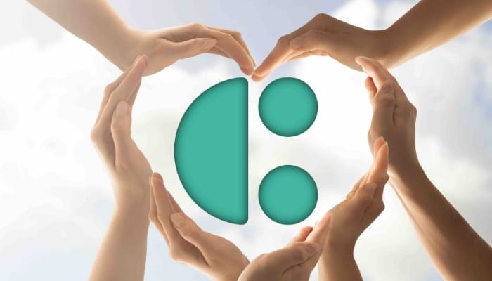 The System C logo with people's hands forming a heart shape around it.