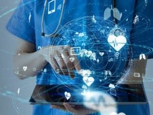 A picture of a healthcare professional on an electronic device displaying an EPR system.