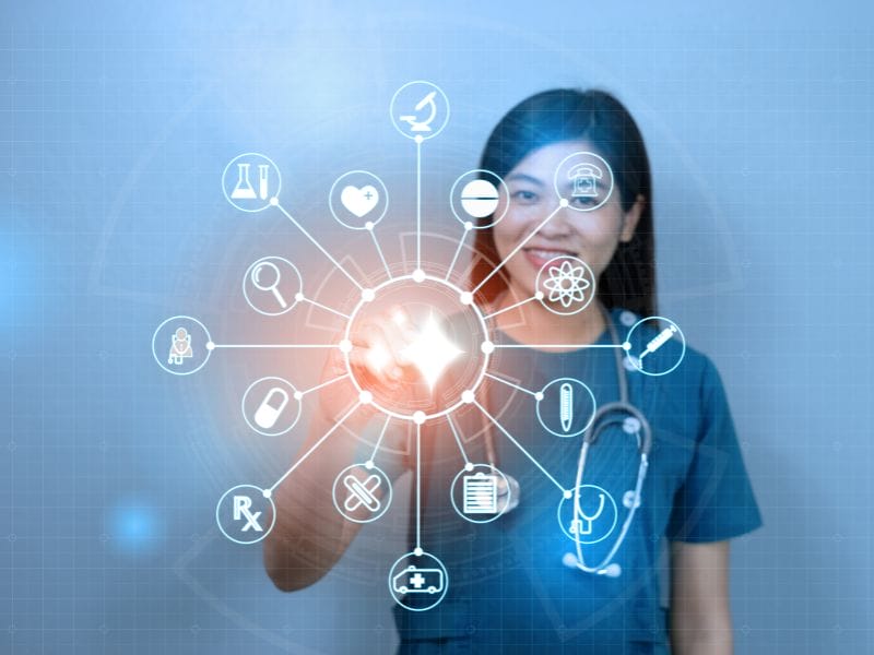 A picture of a healthcare worker using System C's CareFlow Ambient AI solution on an electronic device.