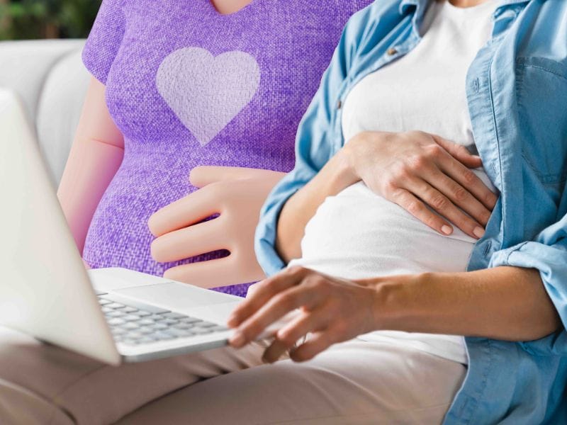An expecting mother looking at healthcare solutions on a laptop device.