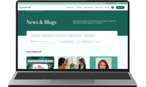 A picture of System C News & Blogs page on a laptop.