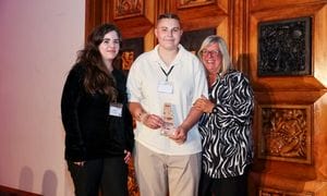 A picture of 3 people holding a trophy at the Frontline Awards 2025.