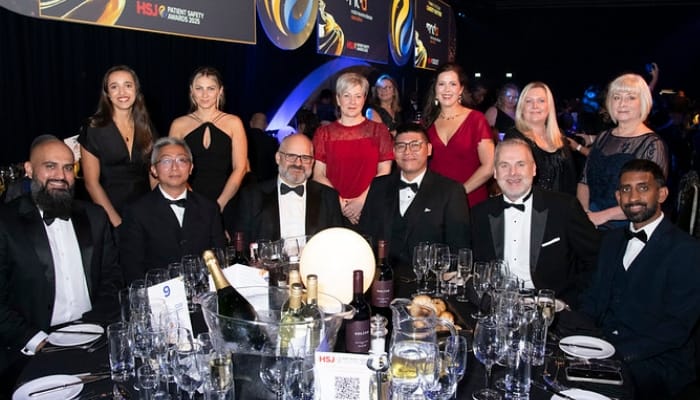 A picture of System C customers smiling at an awards show.