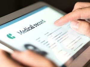 An image of a Clinician using a Mobile Device version of CareFlow EPR.