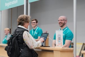Smiling System C staff registering customers to UserCon 2026.