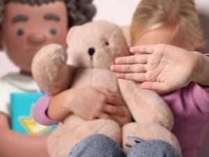 A System C character helping a Child hiding from the Camera.