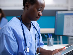 A doctor using a tablet to read results in the EPR solution.